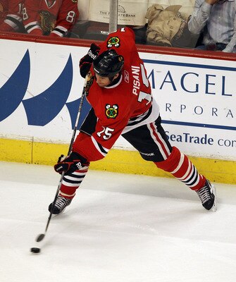 CHICAGO, IL - MARCH 23: Fernando Pisani #15 of the Chicago Blackhawks shoots the puck against the Florida Panthers at the United Center on March 23, 2011 in Chicago, Illinois. The Blackhawks defeated the Panthers 4-0. (Photo by Jonathan Daniel/Getty Image
