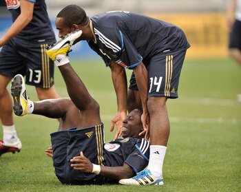 COLUMBUS, OH - AUGUST 20:  Freddy Adu #11 of the Philadelphia Union has a laugh as he falls down on to teammate Amobi Okugo #14 of the Philadelphia Union during pregame warmups before a game against the Columbus Crew on August 20, 2011 at Crew Stadium in 