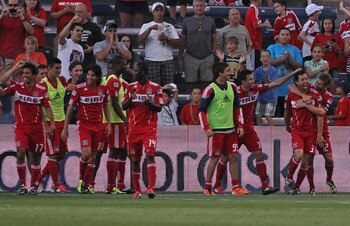 BRIDGEVIEW, IL - AUGUST 21: Members of the Chicago Fire celebrate a goal scored by Dan Gargan #3 (R with teammates Marco Pappa #16 and Logan Pause #12) against Toronto FC during an MLS match at Toyota Park on August 21, 2011 in Bridgeview, Illinois. The F