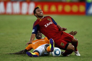 HOUSTON, TX - AUGUST 20: Arturo Alvarez #10 of Real Salt Lake is tackled by Je-Vaughn Watson #10 of the Houston Dynamo at Robertson Stadium on August 20, 2011 in Houston, Texas.  (Photo by Eric Christian Smith/Getty Images)