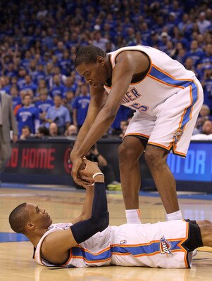 OKLAHOMA CITY, OK - MAY 23:  Kevin Durant #35 helps up teammate Russell Westbrook #0 of the Oklahoma City Thunder in the first half while taking on the Dallas Mavericks in Game Four of the Western Conference Finals during the 2011 NBA Playoffs at Oklahoma