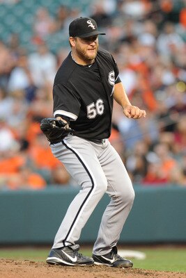BALTIMORE, MD - AUGUST 11:  Mark Buehrle #56 of the Chicago White Sox grabs a line drive during a baseball game against the Baltimore Orioles at Oriole Park at Camden Yards on August 11, 2011 in Baltimore, Maryland.  (Photo by Mitchell Layton/Getty Images