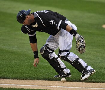 CHICAGO, IL - AUGUST 12: A.J. Pierzynski #12 of the Chicago White Sox fields a bunt against the Kansas City Royals on August 12, 2011 at U.S. Cellular Field in Chicago, Illinois.  (Photo by David Banks/Getty Images)