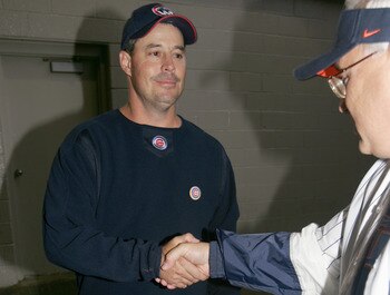 CHICAGO - SEPTEMBER 15: Greg Maddux (R) of the Chicago Cubs collects donations from fans for the victims of Hurricane Katrina before the Cubs game against the St. Louis Cardinals on September 15, 2005 at Wrigley Field in Chicago, Illinois. (Photo by Jonat