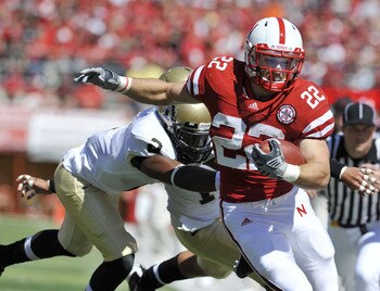 LINCOLN, NEBRASKA - SEPTEMBER 11: Nebraska Cornhuskers running back Rex Burkhead #22 tries to elude Idaho Vandals cornerback Kenneth Patten #2 during first half action of their game at Memorial Stadium on September 4, 2010 in Lincoln, Nebraska. Nebraska d