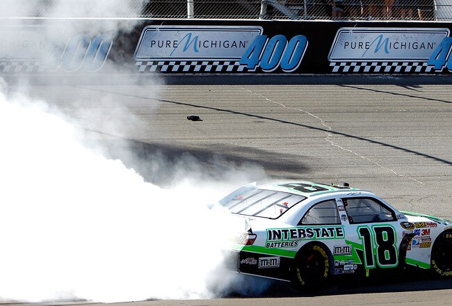 BROOKLYN, MI - AUGUST 21:  Kyle Busch, driver of the #18 Interstate Batteries Toyota, celebrates with a burnout after winning the NASCAR Sprint Cup Series Pure Michigan 400 at Michigan International Speedway on August 21, 2011 in Brooklyn, Michigan.  (Pho
