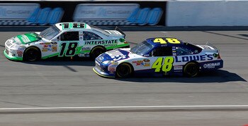 BROOKLYN, MI - AUGUST 21:  Kyle Busch, driver of the #18 Interstate Batteries Toyota, races Jimmie Johnson, driver of the #48 Lowe's Chevrolet, during the NASCAR Sprint Cup Series Pure Michigan 400 at Michigan International Speedway on August 21, 2011 in