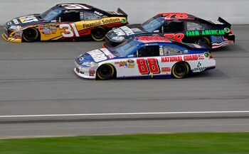 BROOKLYN, MI - AUGUST 21:    Jeff Burton, driver of the #31 Caterpillar/Cat Financial Chevrolet, races Regan Smith, driver of the #78 Furniture Row/Farm American Chevrolet, and Dale Earnhardt Jr., driver of the #88 National Guard/Amp Energy Chevrolet, dur