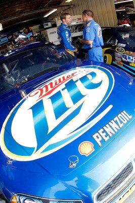 BROOKLYN, MI - AUGUST 20:  Brad Keselowski(L), driver of the #2 Miller Lite Dodge, talks with a crew member prior to practice for the NASCAR Sprint Cup Series Pure Michigan 400 at Michigan International Speedway on August 20, 2011 in Brooklyn, Michigan.