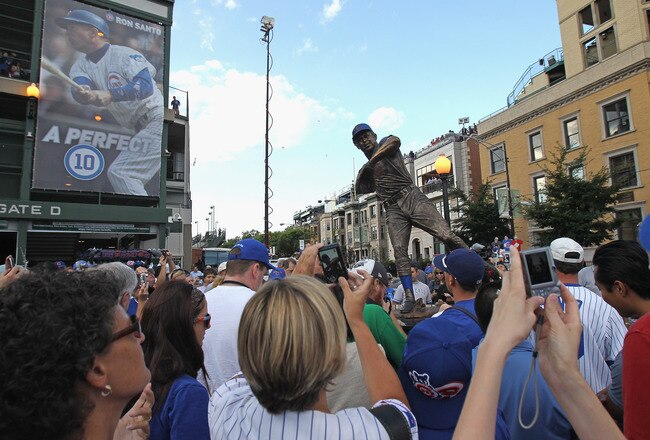 CHICAGO, IL - AUGUST 10: Fans take photos of a statue of former Chicago Cub player and broadcaster Ron Santo which was unveiled outside of Wrigley Field before a game between the Cubs and the Washington Nationals on August 10, 2011 in Chicago, Illinois. (