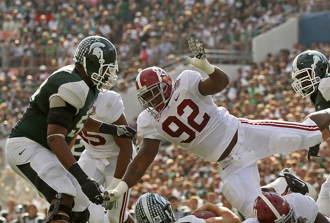 ORLANDO, FL - JANUARY 01:  Kirk Cousins #8  of the Michigan State Spartans is sacked by Courtney Upshaw #41 of the Alabama Crimson Tide during the Capitol One Bowl at the Florida Citrus Bowl on January 1, 2011 in Orlando, Florida.  (Photo by Mike Ehrmann/