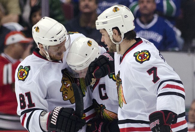 VANCOUVER, CANADA - APRIL 26: Jonathan Toews #19 of the Chicago Blackhawks is congratulated by Marian Hossa #81 and Brent Seabrook #7 after scoring the game tying goal during the third period in Game Seven of the Western Conference Quarterfinals during th