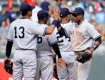 MINNEAPOLIS, MN - AUGUST 21: Alex Rodriguez #13 and Curtis Granderson #14 of the New York Yankees celebrate a win against the Minnesota Twins on August 21, 2011 at Target Field in Minneapolis, Minnesota. The Yankees defeated the Twins 3-0. (Photo by Hanna