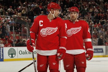 DETROIT, MI - FEBRUARY 24:  Nicklas Lidstrom #5 and Henrik Zetterberg #40 of the Detroit Red Wings talk to each other while playing the Dallas Stars on February 24, 2011 at Joe Louis Arena in Detroit, Michigan.  (Photo by Gregory Shamus/Getty Images)