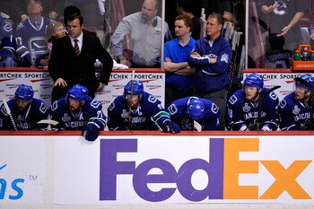 VANCOUVER, BC - JUNE 15:  Head coach Alain Vigneault (Top Left) of the Vancouver Canucks looks on from the bench against the Boston Bruins during Game Seven of the 2011 NHL Stanley Cup Final at Rogers Arena on June 15, 2011 in Vancouver, British Columbia,