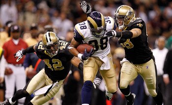 NEW ORLEANS, LA - DECEMBER 12: Keith Toston #38 of the St. Louis Rams is tackled by Darren Sharper #42 and Scott Shanle #58 of the New Orleans Saints at the Louisiana Superdome on December 12, 2010 in New Orleans, Louisiana. The Saints defeated the Rams 3