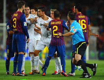 BARCELONA, SPAIN - AUGUST 17:  Cristiano Ronaldo of Real Madrid squares up to Andres Iniesta of Barcelona during the second goal during the Super Cup second leg match between Barcelona and Real Madrid at Nou Camp on August 17, 2011 in Barcelona, Spain.  (