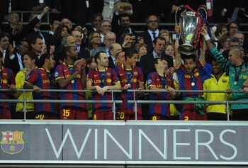 LONDON, ENGLAND - MAY 28:  Eric Abidal (R) of FC Barcelona lifts the trophy and celebrates with teammates after victory in the UEFA Champions League final between FC Barcelona and Manchester United FC at Wembley Stadium on May 28, 2011 in London, England.