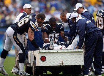 SAN DIEGO - JANUARY 06:  Antonio Gates #85 of the San Diego Chargers is attended to by teammate Shawne Merriman #56 prior to being carter off the field after injuring his ankle in the second quarter during their AFC Wild Card Playoff Game against the Tenn
