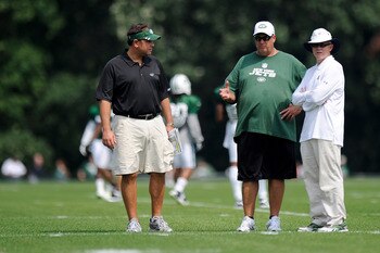 FLORHAM PARK, NJ - AUGUST 07:  General manager Mike Tannenbaum of the New York Jets (L) talks with Head coach Rex Ryan and owner Woody Johnson during the afternoon practice at NY Jets Practice Facility on August 7, 2011 in Florham Park, New Jersey.  (Phot