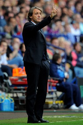 BOLTON, ENGLAND - AUGUST 21:   Manchester City Manager Roberto Mancini gestures during the Barclays Premier League match between Bolton Wanderers and Manchester City at the Reebok Stadium on August 21, 2011 in Bolton, England.  (Photo by Michael Regan/Get