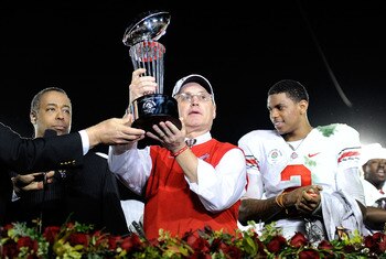 PASADENA, CA - JANUARY 01:  (C) Head coach Jim Tressel of the Ohio State Buckeyes celebrates with the Rose Bowl championship trophy as quarterback Terrelle Pryor #2 looks on after the buckeyes 26-17 win in the 96th Rose Bowl game over the Oregon Ducks on
