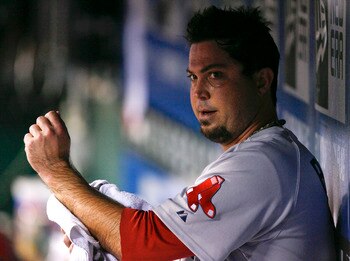 KANSAS CITY, MO - AUGUST 18:  Starting pitcher Josh Beckett #19 of the Boston Red Sox wipes down his arm in the dugout during a game against the Kansas City Royals in the seventh inning at Kauffman Stadium on August 18, 2011 in Kansas City, Missouri. (Pho
