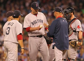 SEATTLE - AUGUST 12:  Starting pitcher John Lackey #41 of the Boston Red Sox is removed from the game by manager Terry Francona #47 in the seventh inning against the Seattle Mariners at Safeco Field on August 12, 2011 in Seattle, Washington. (Photo by Ott