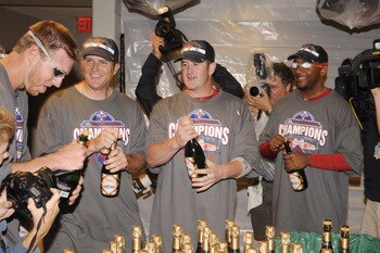 WASHINGTON - SEPTEMBER 27:  Roy Halliday, Mike Sweeney, Brian Schneider and Ben Francisco of the Philadelphia Phillies celebrate clinching the National League east title after a baseball game against the Washington Nationals on September 27, 2010 at Natio