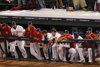 ARLINGTON, TX - OCTOBER 31:  Players from the Texas Rangers look on dejected from the dugout against the San Francisco Giants in Game Four of the 2010 MLB World Series at Rangers Ballpark in Arlington on October 31, 2010 in Arlington, Texas.  (Photo by Ro