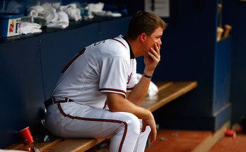 ATLANTA - JUNE 27:  Chipper Jones #10 of the Atlanta Braves sits dejected in the dugout after falling to the Boston Red Sox 1-0 at Turner Field on June 27, 2009 in Atlanta, Georgia.  (Photo by Kevin C. Cox/Getty Images)