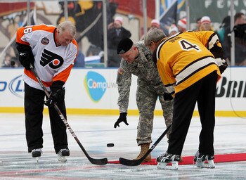 BOSTON - JANUARY 01:  Staff Sergeant Ryan R. LaFrance (C) drops the ceremonial first puck for Bobby Clarke #16 (L) honorary captain of the Philadelphia Flyers and Bobby Orr #4 (R) honorary captain of the Boston Bruins during the 2010 Bridgestone Winter Cl