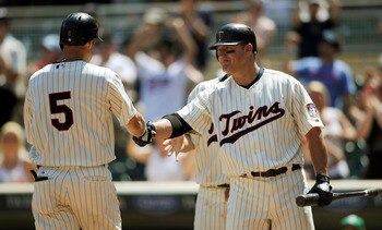 MINNEAPOLIS, MN - JULY 18: Jim Thome #25 of the Minnesota Twins congratulates Michael Cuddyer #5 of the Minnesota Twins on a two-run home run against the Cleveland Indians in the ninth inning of game one in a double header on July 18, 2011 at Target Field