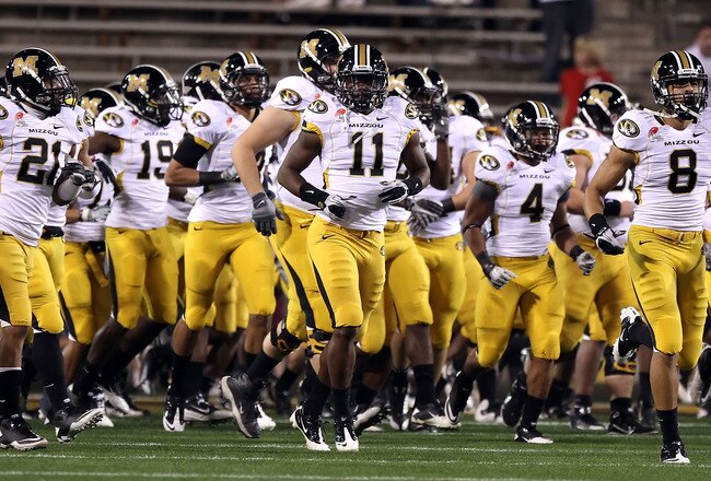 TEMPE, AZ - DECEMBER 28:  Jarrell Harrison #11 (C) of the Missouri Tigers runs onto the field with teammates before the Insight Bowl against the Iowa Hawkeyes at Sun Devil Stadium on December 28, 2010 in Tempe, Arizona.  (Photo by Christian Petersen/Getty