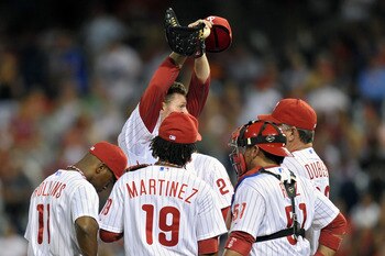 PHILADELPHIA, PA - AUGUST 16: Roy Halladay #34 of the Philadelphia Phillies stretches while talking to coach Rich Dubee #30 after giving up a  two runs in the ninth inning to the Arizona Diamondbacks at Citizens Bank Park on August 16, 2011 in Philadelphi