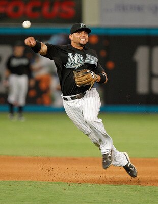 MIAMI GARDENS, FL - AUGUST 24: Omar Infante #13 of the Florida Marlins makes a throw to first during game two of a doubleheader against the Cincinnati Reds at Sun Life Stadium on August 24, 2011 in Miami Gardens, Florida.  (Photo by Mike Ehrmann/Getty Ima