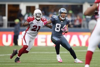 SEATTLE - OCTOBER 18:  T.J. Houshmandzadeh  #84 of the Seattle Seahawks looks to catch the pass against Antrel Rolle #21 of the Arizona Cardinals on October 18, 2009 at Qwest Field in Seattle, Washington. (Photo by Otto Greule Jr/Getty Images)