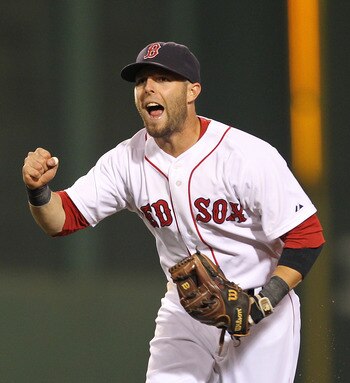 BOSTON - AUGUST 16:  Dustin Pedroia #15 of the Boston Red Sox reacts after the Red Sox turn a triple play against the Tampa Bay Rays in the third inning in the second game of a doubleheader at Fenway Park on August 16, 2011 in Boston, Massachusetts.  (Pho