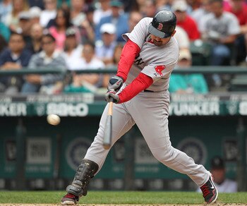 SEATTLE - AUGUST 14:  Adrian Gonzalez #28 of the Boston Red Sox singles in the sixth inning against the Seattle Mariners at Safeco Field on August 14, 2011 in Seattle, Washington. (Photo by Otto Greule Jr/Getty Images)