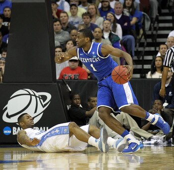 NEWARK, NJ - MARCH 27:  Darius Miller #1 of the Kentucky Wildcats dribbles as Leslie McDonald #2 of the North Carolina Tar Heels gets pushed on the floor during the east regional final of the 2011 NCAA men's basketball tournament at Prudential Center on M