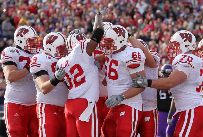 PASADENA, CA - JANUARY 01:  Running back John Clay #32 of the Wisconsin Badgers celebrates with teammates after scoring a touchdown in the first quarter against the TCU Horned Frogs during the 97th Rose Bowl game on January 1, 2011 in Pasadena, California