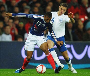 LONDON, ENGLAND - NOVEMBER 17:  Yann M'Vila (L) of France holds off the challenge of Jordan Henderson (R) of England during the international friendly match between England and France at Wembley Stadium on November 17, 2010 in London, England.  (Photo by 