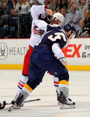 NASHVILLE, TN - APRIL 08:  Derek MacKenzie #24 of the Columbus Blue Jackets fights Blake Geoffrion #5 of the Nashville Predators on April 8, 2011 at the Bridgestone Arena in Nashville, Tennessee.  (Photo by Frederick Breedon/Getty Images)