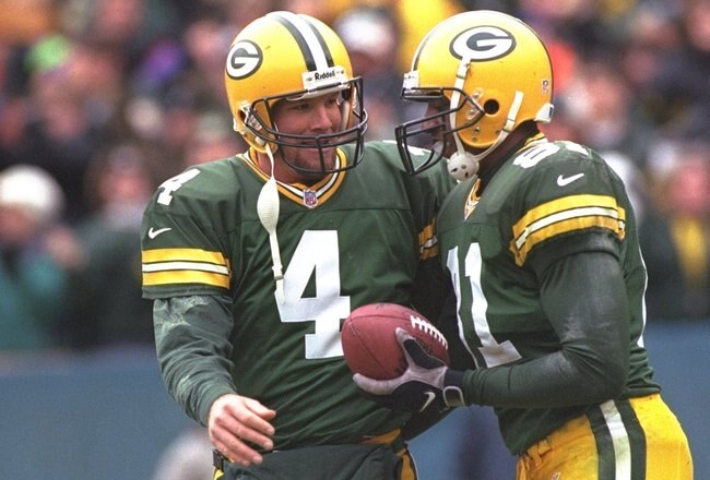 20 Dec 1997: Quarterback Brett Favre #4 of the Green Bay Packers celebrates with teammate Tyrone Davis #81 during the Packers 31-21 win over the Buffalo Bills at Lambeau Field in Green Bay, Wisconsin.