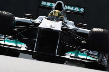SPA FRANCORCHAMPS, BELGIUM - AUGUST 26:  Michael Schumacher of Germany and Mercedes GP drives wearing a specially designed helmet as he commemorates the 20th anniversary of his first F1 race during practice for the Belgian Formula One Grand Prix at the Ci