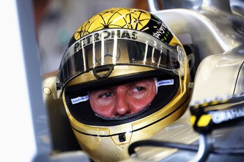 SPA FRANCORCHAMPS, BELGIUM - AUGUST 26:  Michael Schumacher of Germany and Mercedes GP prepares to drive wearing a specially designed gold drivers helmet as he commemorates the 20th anniversary of his first F1 race during practice for the Belgian Formula