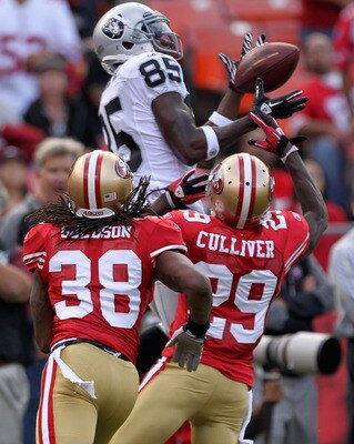 SAN FRANCISCO, CA - AUGUST 20:  Darrius Heyward-Bey #85 of the Oakland Raiders catches the ball while covered by Dashon Goldson #38 and Chris Culliver #29 of the San Francisco 49ers at Candlestick Park on August 20, 2011 in San Francisco, California.  (Ph