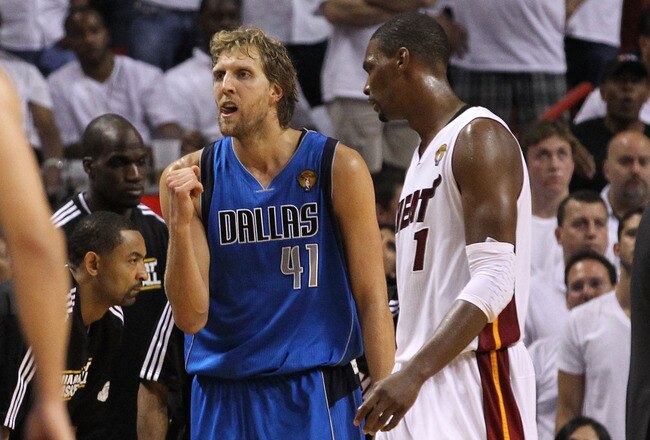MIAMI, FL - JUNE 12:  Dirk Nowitzki #41 of the Dallas Mavericks reacts as Chris Bosh #1 of the Miami Heat walks by in the fourth quarter while taking on the Miami Heat in Game Six of the 2011 NBA Finals at American Airlines Arena on June 12, 2011 in Miami