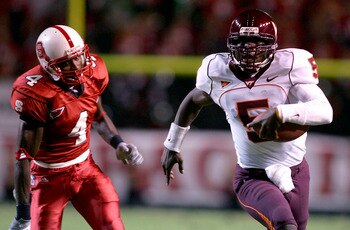 RALEIGH, NC - SEPTEMBER 4:  Quarterback Marcus Vick #5 of the Virginia Tech Hokies runs past free safety J.J. Jones #4 of the North Carolina State Wolfpack at Carter-Finley Stadium on September 4, 2005 in Raleigh, North Carolina. Virginia Tech defeated NC