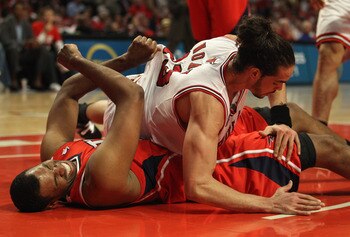 CHICAGO, IL - MAY 10: Joakim Noah #13 of the Chicago Bulls lands on top of Jason Collins #34 of the Atlanta Hawks in Game Five of the Eastern Conference Semifinals in the 2011 NBA Playoffs at the United Center on May 10, 2011 in Chicago, Illinois. The Bul